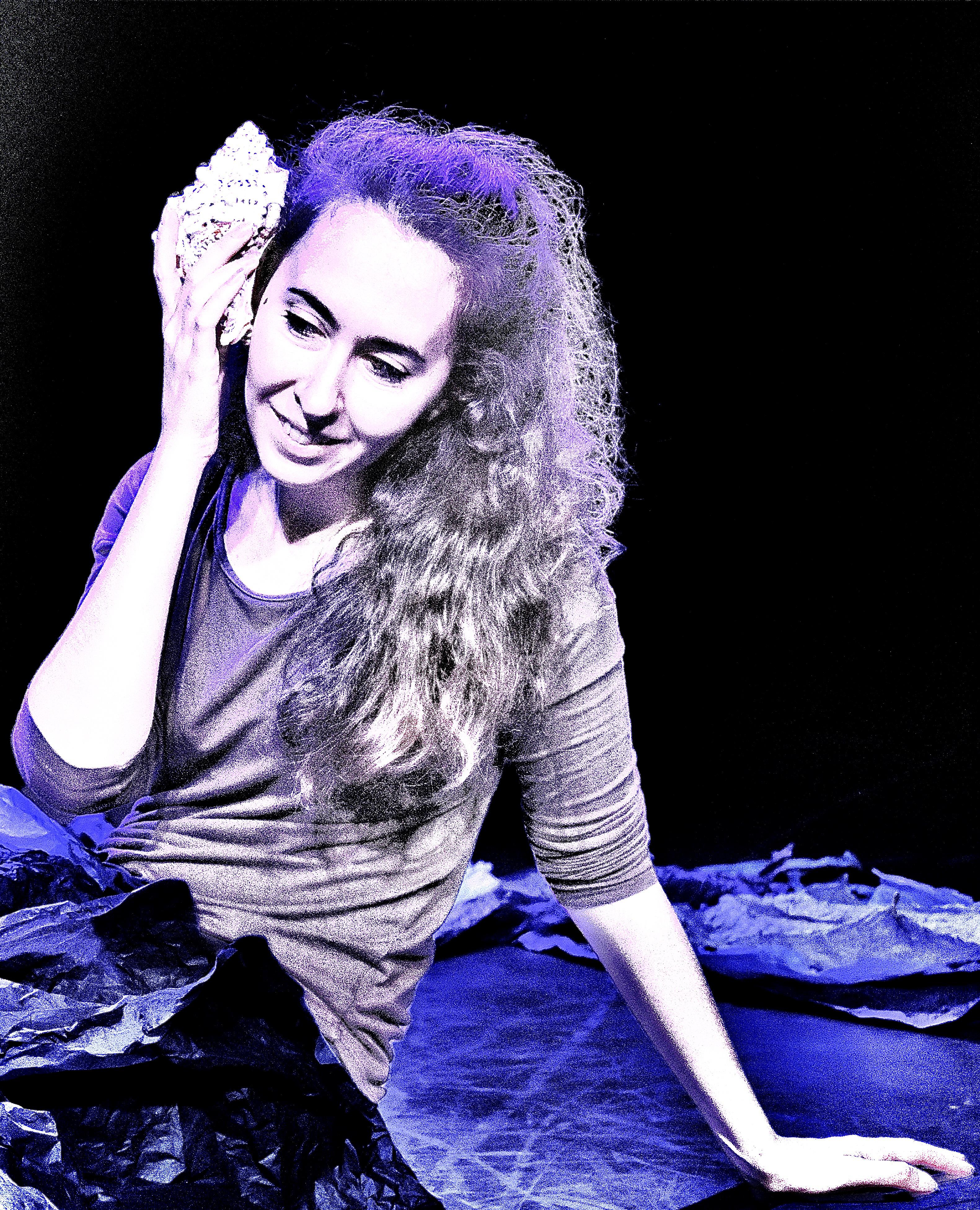 Giorgia holding a seashell to her ear