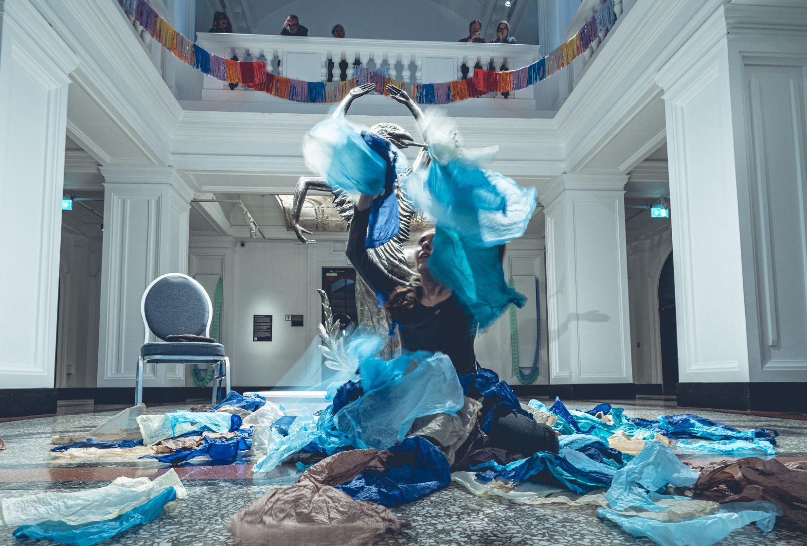 Giorgia throwing blue paper into the air