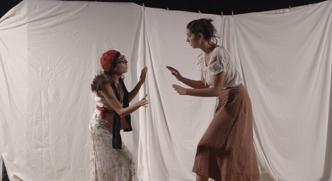 Tall and petite performers interacting on stage