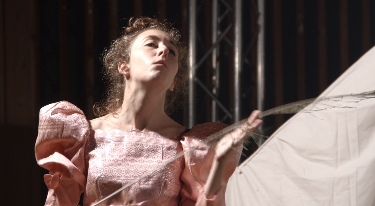 Close-up picture of performer acting snobbish in dress