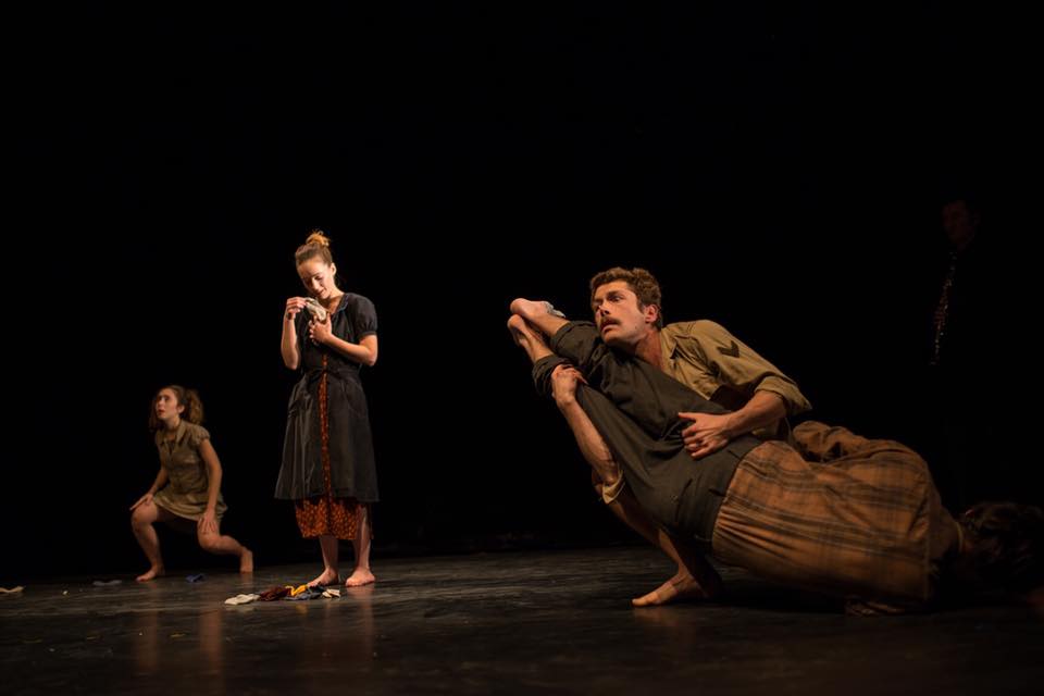 Performers on stage in various physical poses