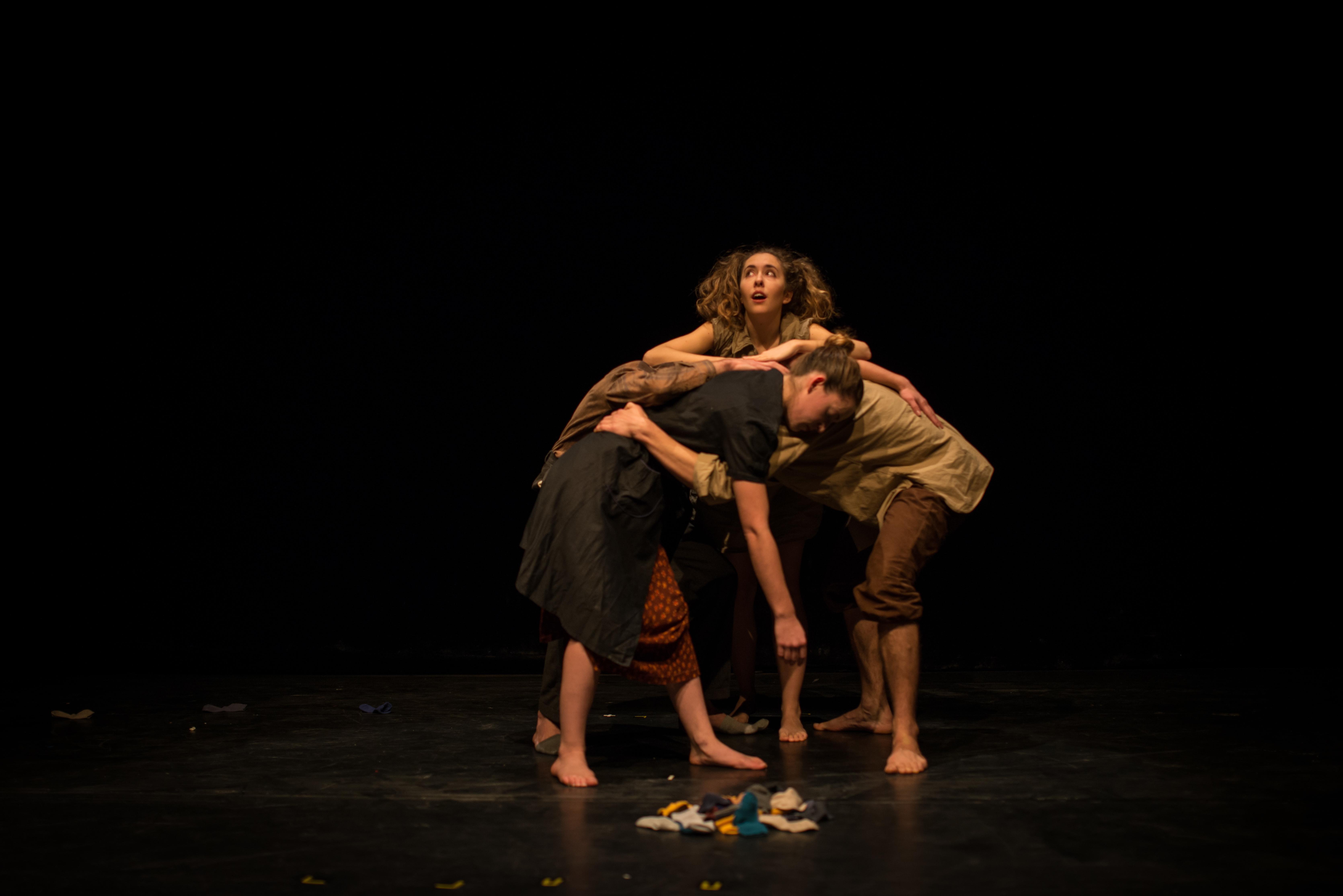 Performers huddled with Giorgia looking outward and over