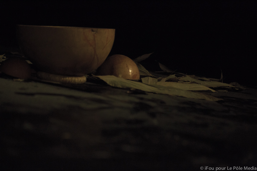 Dark image of wooden bowls and large dried leaves