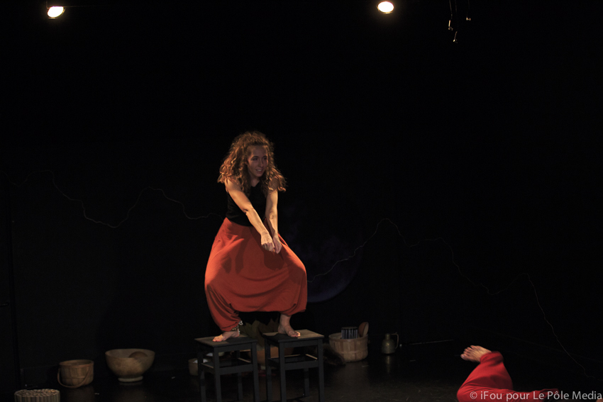 Giorgia in powerful stance, stood on chairs