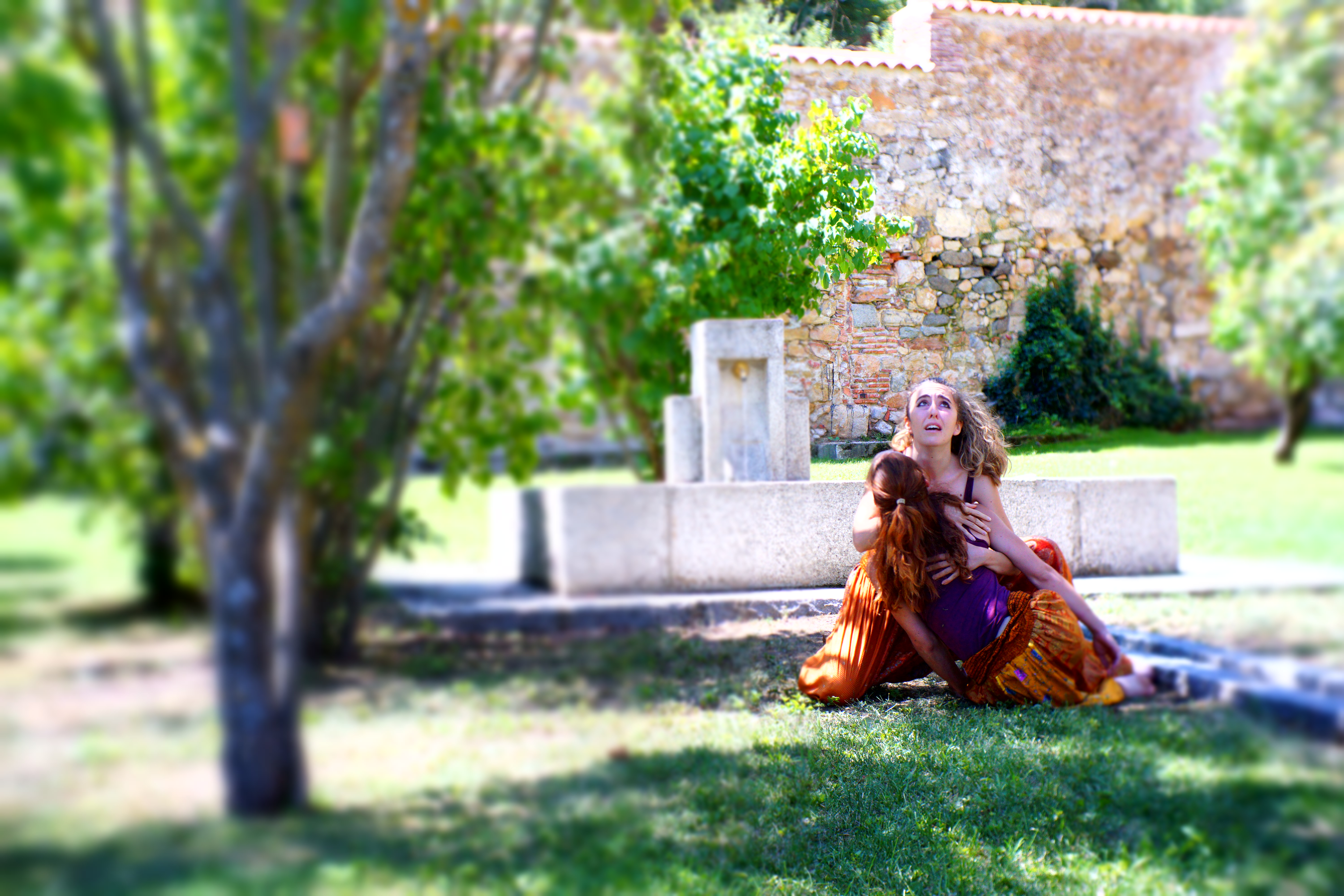 Giorgia holding unconscious performer in arms, looking distraught