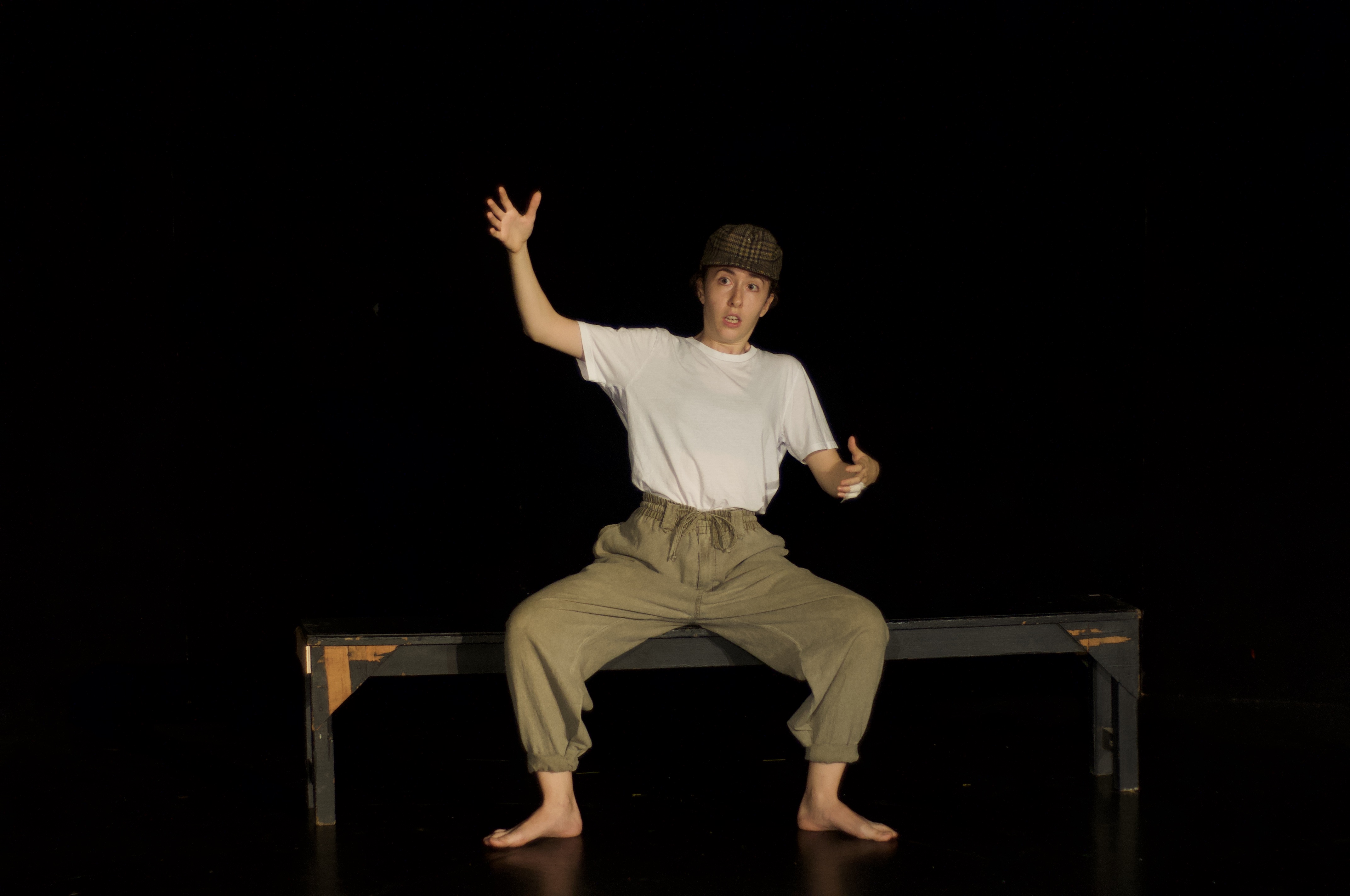 Giorgia storytelling on bench wearing hat