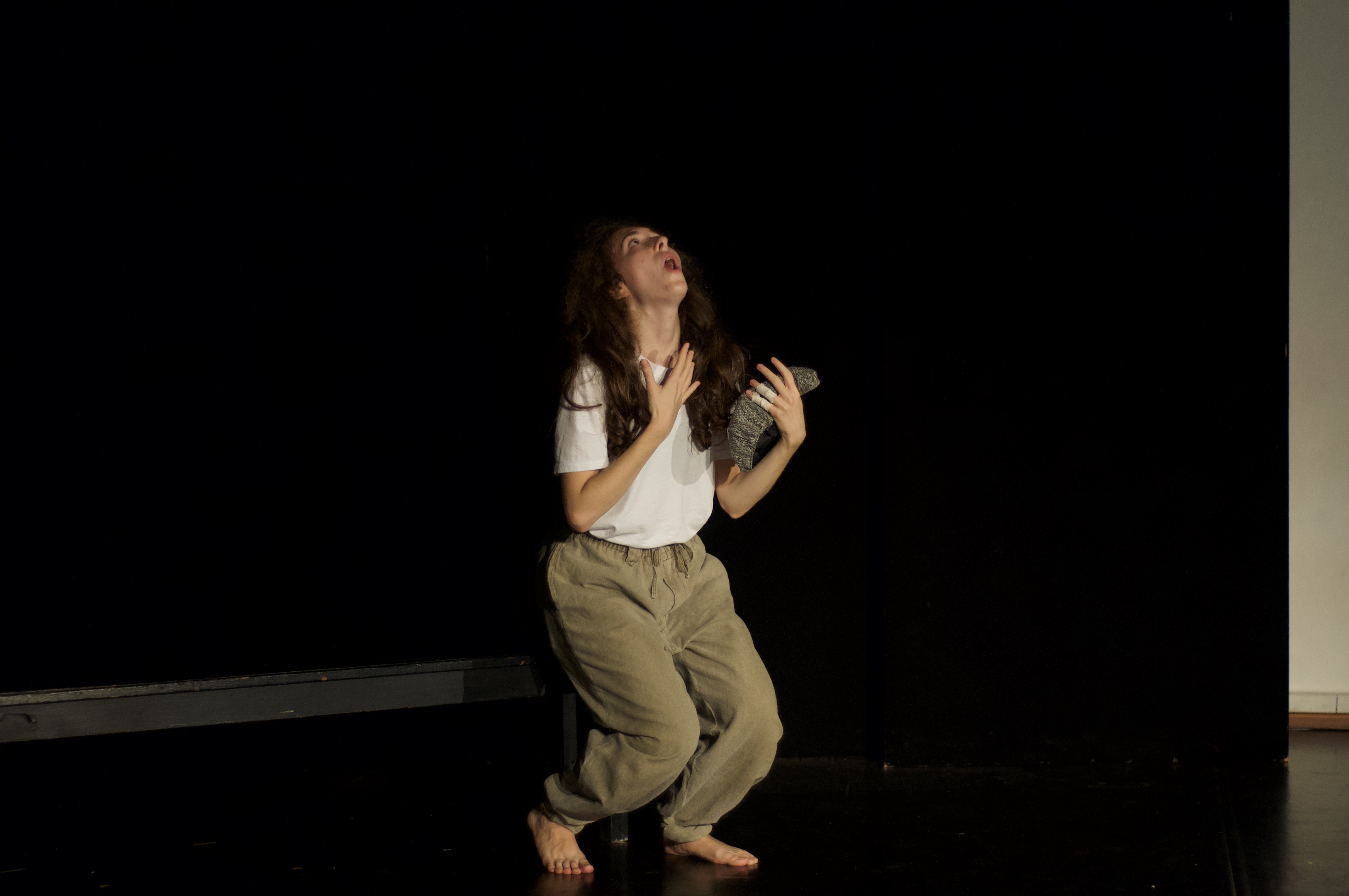 Giorgia lamenting to the sky holding hat